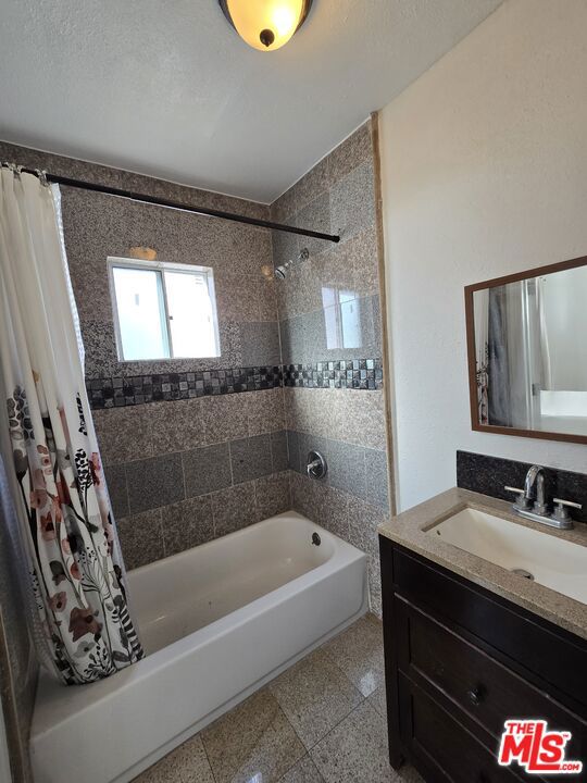 bathroom with vanity and shower / tub combo