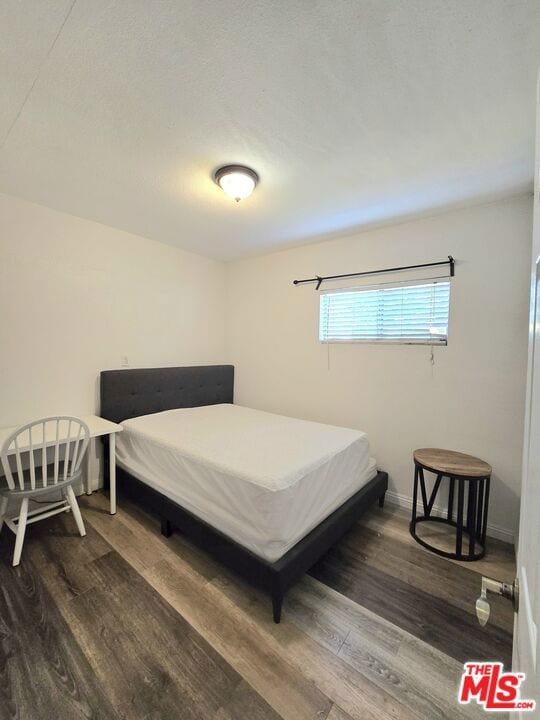 bedroom featuring dark hardwood / wood-style flooring