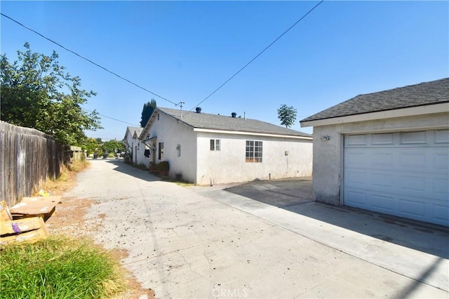 view of property exterior with an outbuilding and a garage