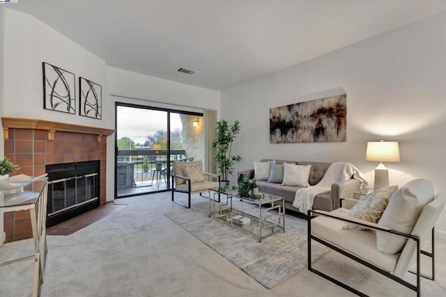 carpeted living room featuring a fireplace