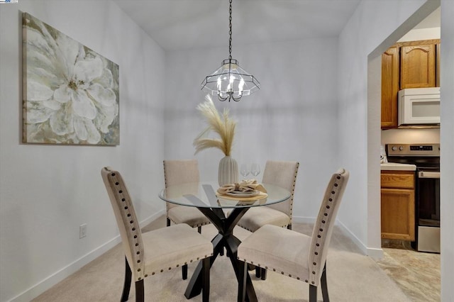 carpeted dining room with a notable chandelier