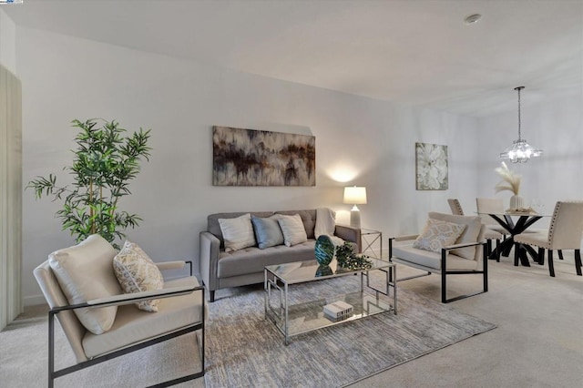 living room with light colored carpet and a chandelier