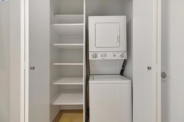 washroom featuring stacked washer / drying machine