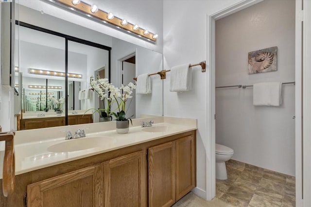 bathroom with vanity and toilet