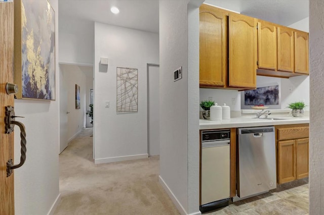 kitchen featuring stainless steel dishwasher and light colored carpet