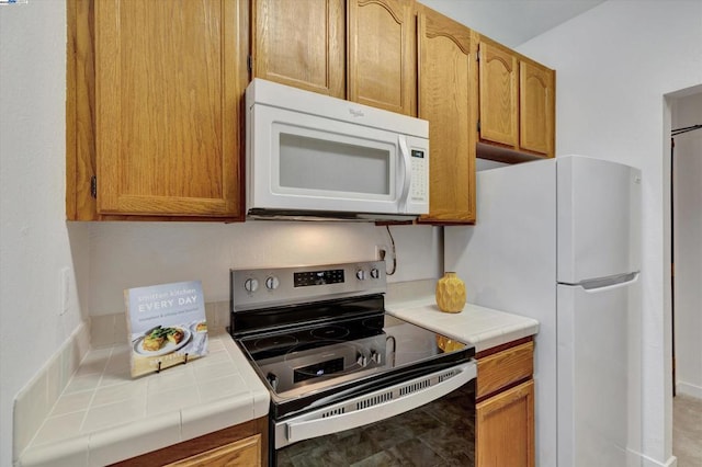 kitchen with white appliances and tile counters