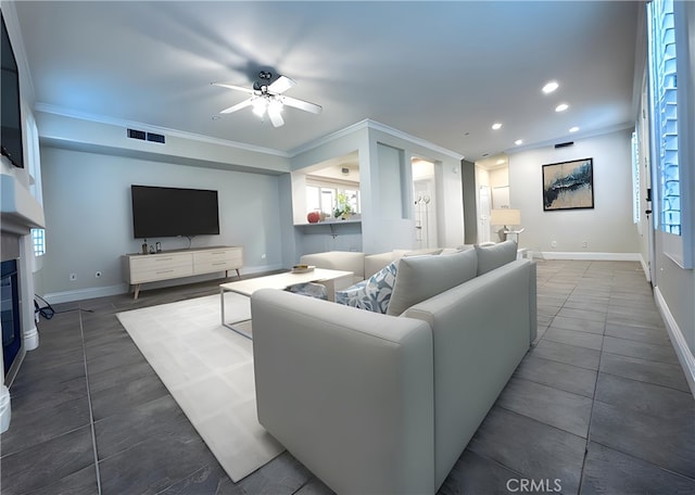 living room featuring ceiling fan and ornamental molding