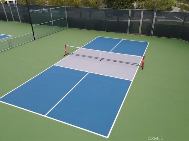 view of sport court with basketball hoop