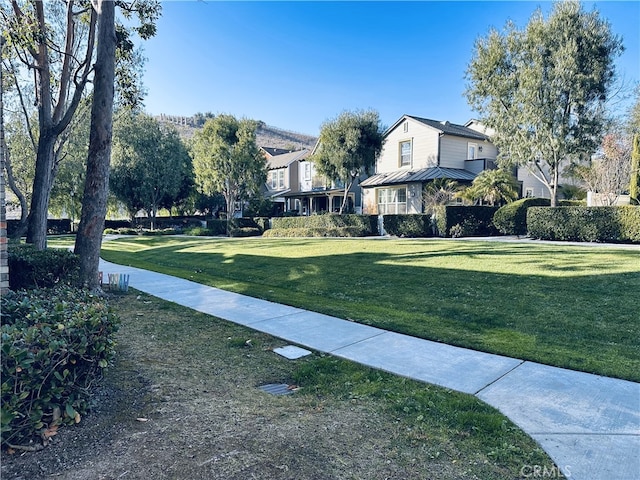 view of home's community featuring a lawn