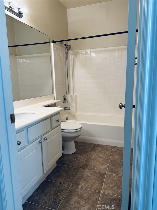 full bathroom with vanity, tiled shower / bath, and toilet