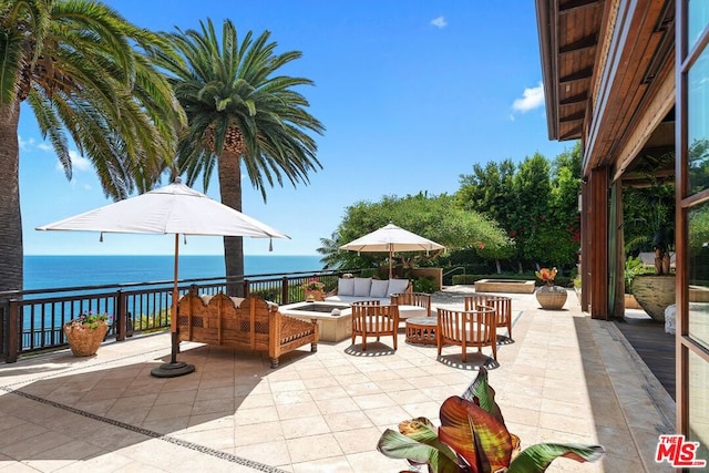 view of patio with a water view and outdoor lounge area