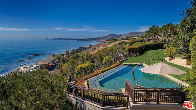 view of pool with a water and mountain view and a patio