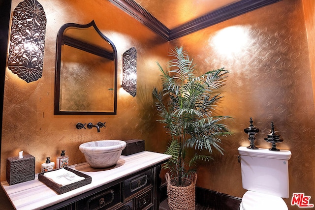 bathroom with crown molding, vanity, and toilet