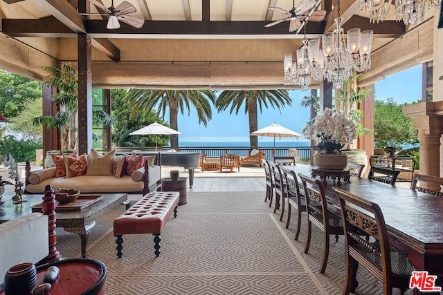 view of patio / terrace featuring outdoor lounge area, ceiling fan, and a water view