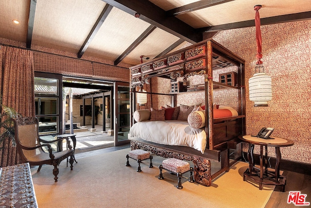 bedroom featuring vaulted ceiling with beams and access to outside