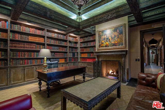 home office with coffered ceiling and built in shelves