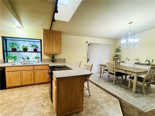 kitchen with sink, an inviting chandelier, hanging light fixtures, a skylight, and black appliances