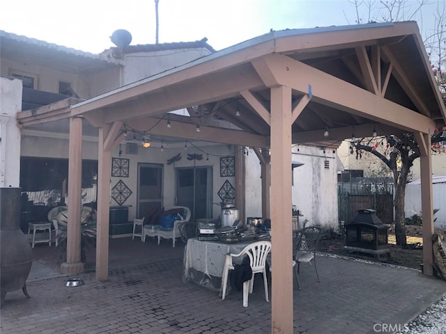 view of patio / terrace featuring a bar and a gazebo