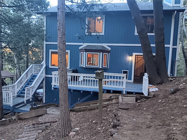 rear view of house featuring a deck