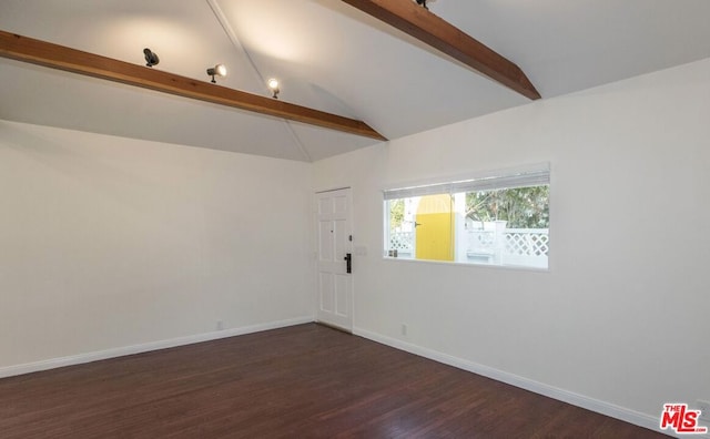 empty room with dark hardwood / wood-style flooring and lofted ceiling with beams