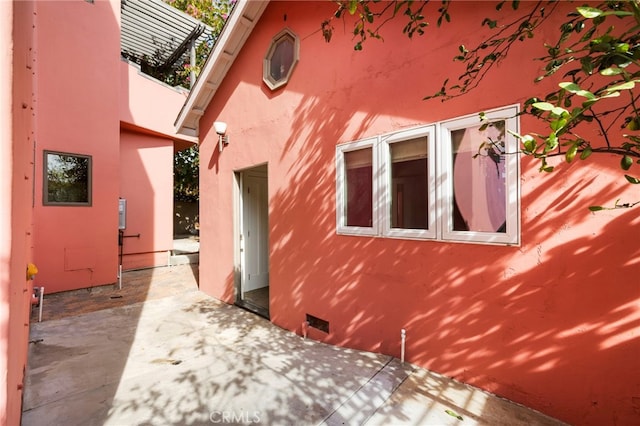 view of side of home with a patio area