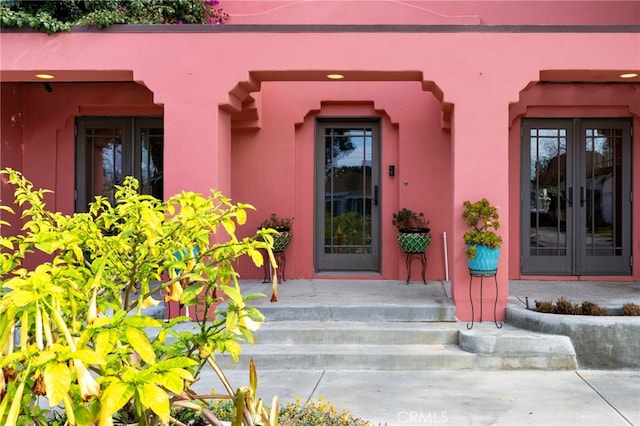 view of exterior entry featuring french doors