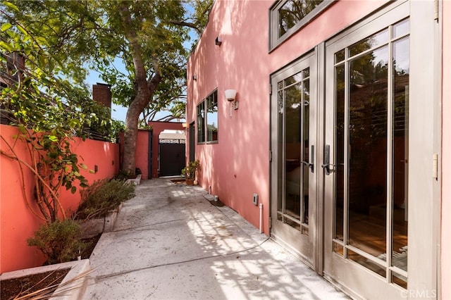 view of property exterior with french doors and a patio