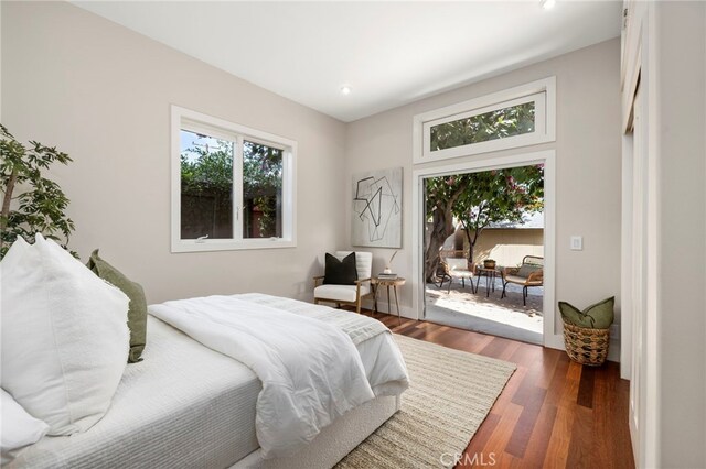 bedroom featuring dark hardwood / wood-style floors and access to exterior