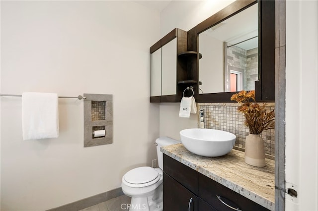 bathroom with vanity, backsplash, tile patterned floors, and toilet