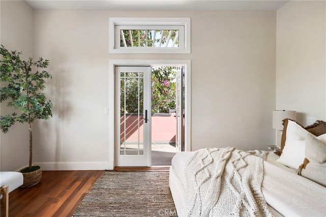 bedroom with dark hardwood / wood-style floors and access to outside