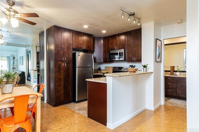 kitchen with ceiling fan, stainless steel appliances, kitchen peninsula, and dark brown cabinets