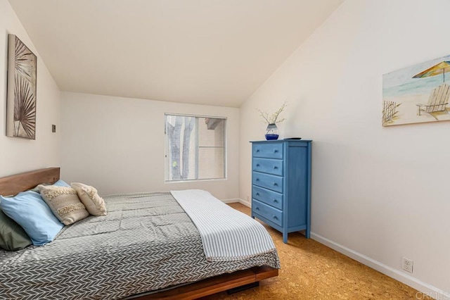 carpeted bedroom featuring lofted ceiling