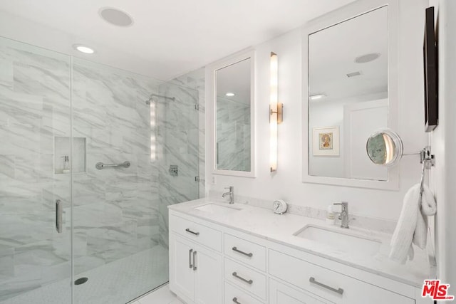 bathroom with vanity and a shower with shower door