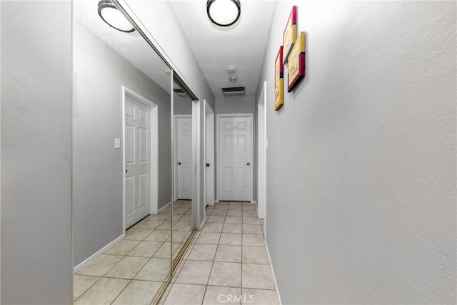 hall with light tile patterned floors