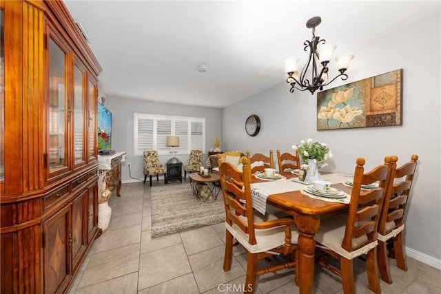 dining area with a chandelier and light tile patterned flooring