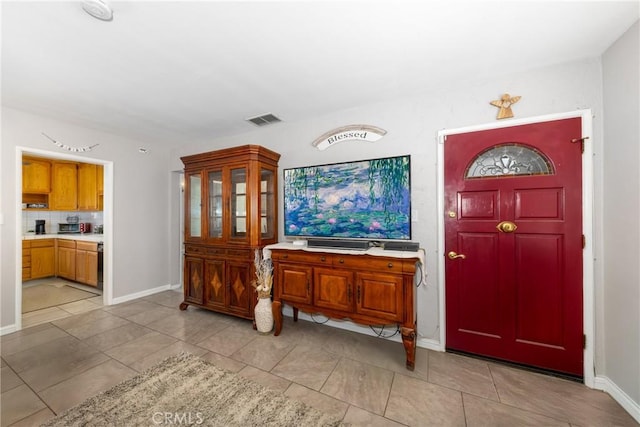 foyer featuring light tile patterned floors