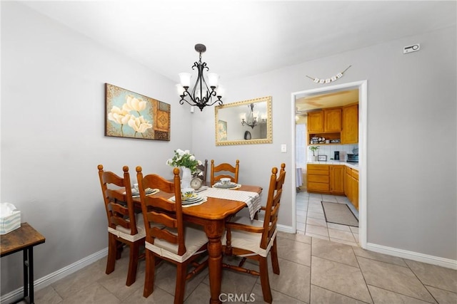 dining area with light tile patterned floors and a notable chandelier