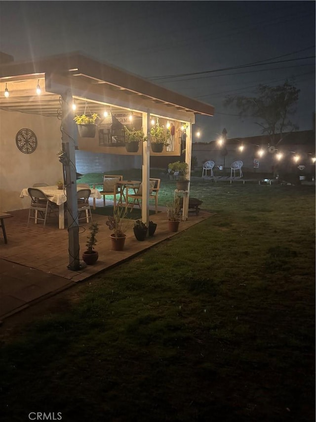 yard at night with a patio