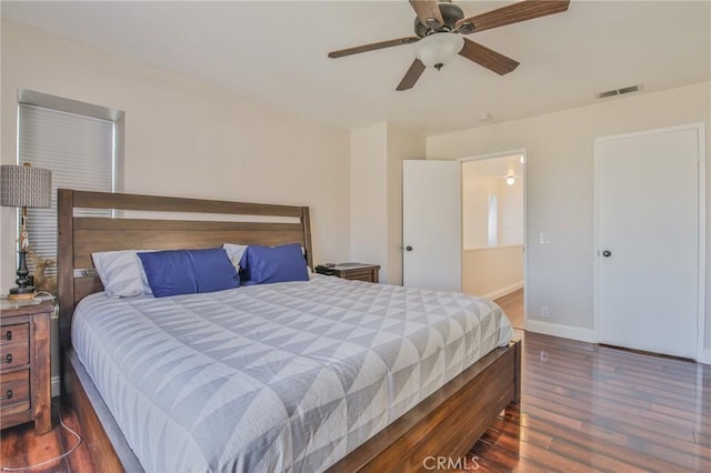 bedroom with dark hardwood / wood-style floors and ceiling fan