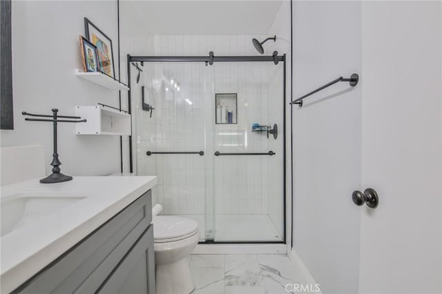 bathroom with walk in shower, vanity, and toilet