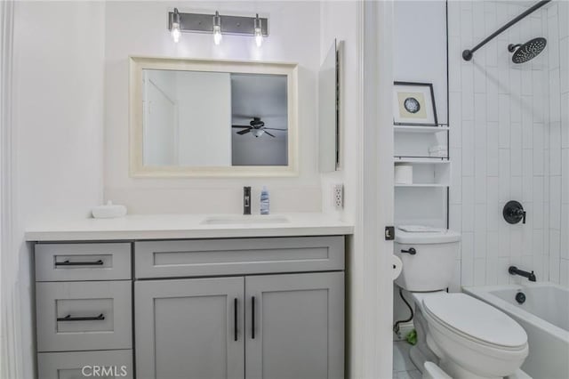 full bathroom with vanity, tiled shower / bath, and toilet