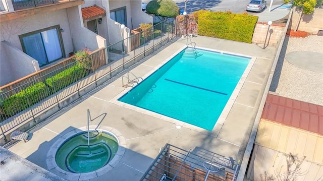 view of pool with an in ground hot tub