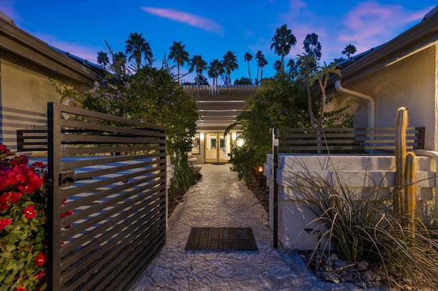 patio terrace at dusk featuring a pergola