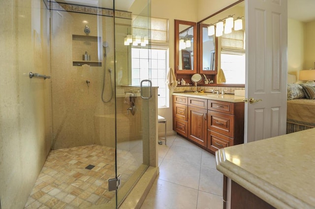 bathroom featuring vanity, tile patterned flooring, a wealth of natural light, and walk in shower