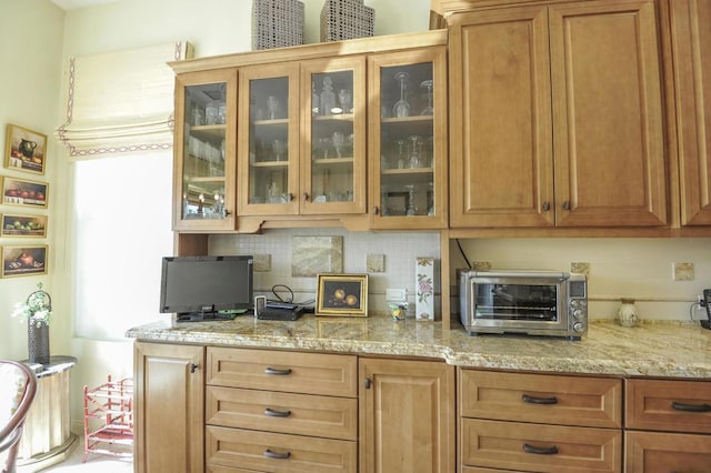 kitchen with tasteful backsplash and light stone countertops