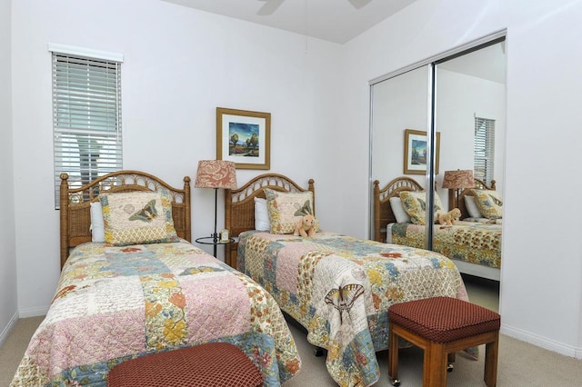 carpeted bedroom with ceiling fan and a closet