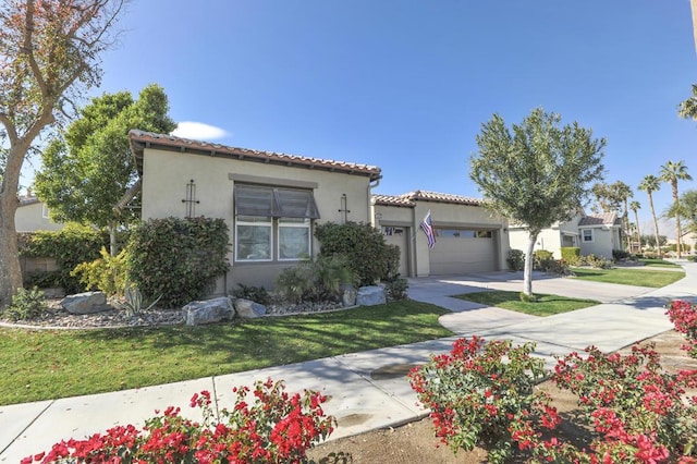 mediterranean / spanish house with a garage and a front yard