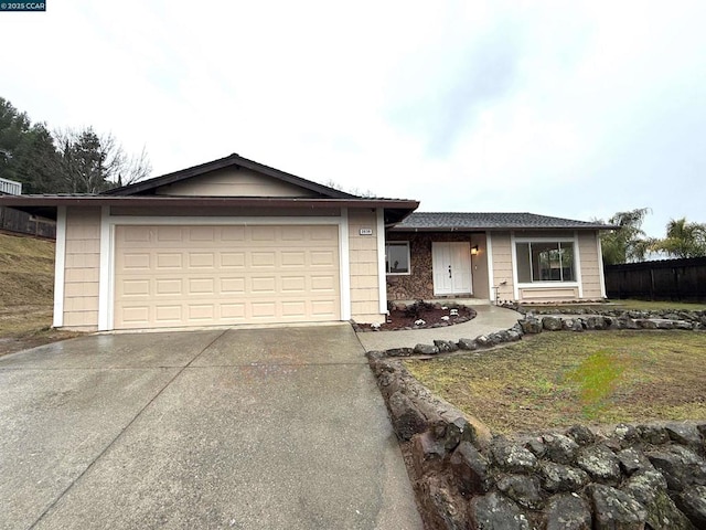 view of front of home with a garage and a front lawn