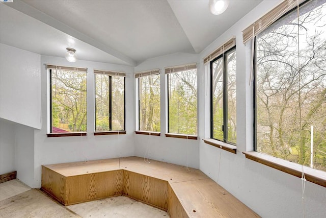 unfurnished sunroom featuring lofted ceiling