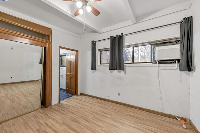 unfurnished bedroom featuring beam ceiling, ceiling fan, and hardwood / wood-style flooring